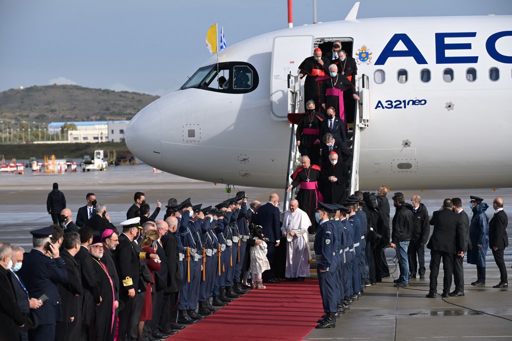 Pope Francis (C,down) followed by his delegation steps out a plane upon his arrival in Athens airport on December 4, 2021.