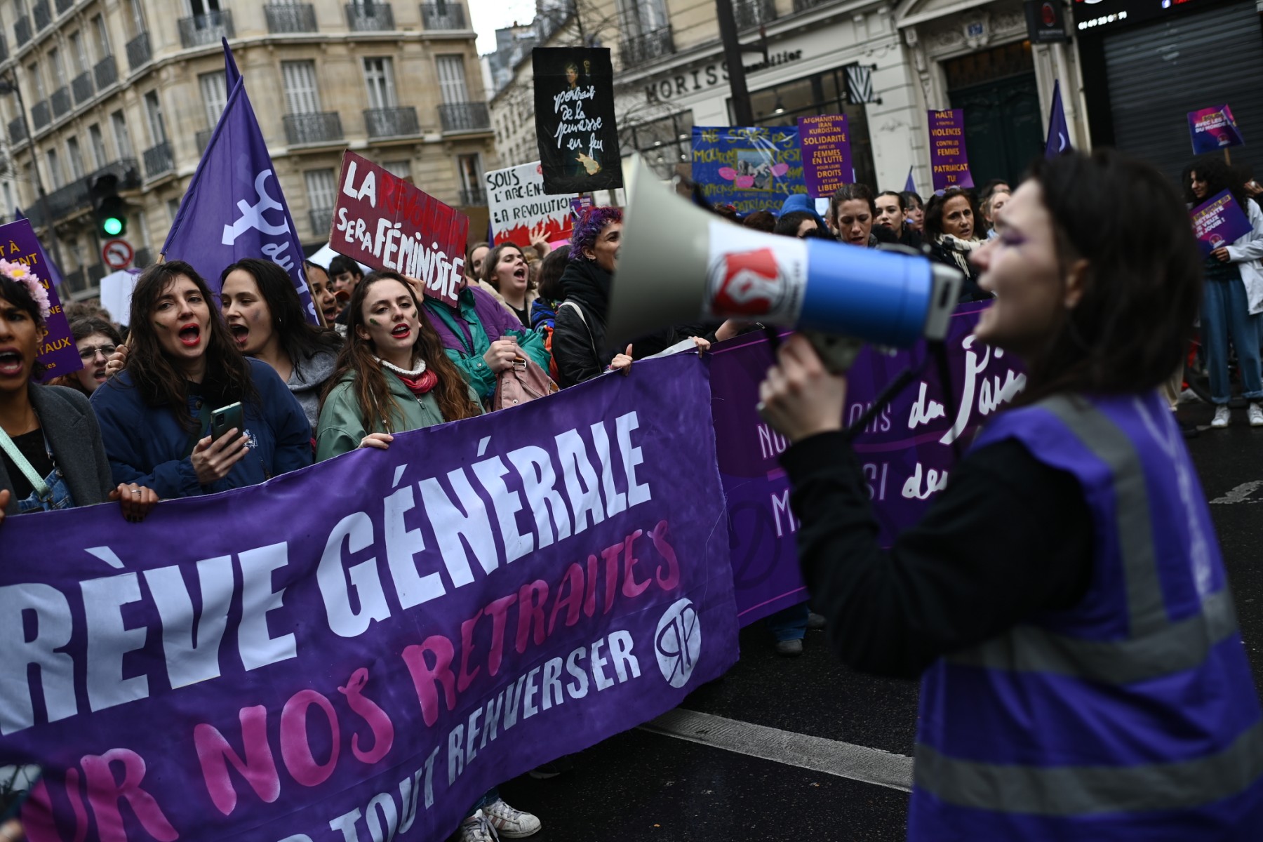 Des femmes tiennent une banderole indiquant «Grève générale pour nos retraites» alors qu'elles participent à un rassemblement pour marquer la Journée internationale de la femme à Paris, le 8 mars 2023 (Photo, AFP).