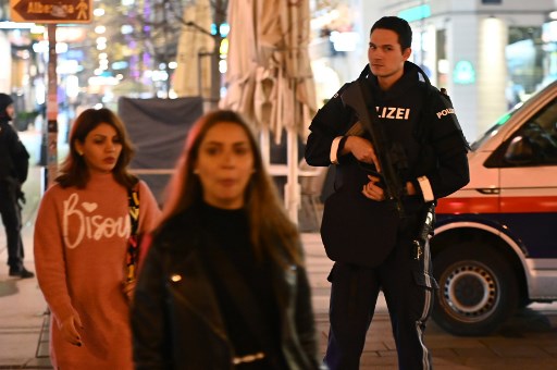 Un policier monte la garde près de la scène, alors que des piétons passent (Photo, AFP)