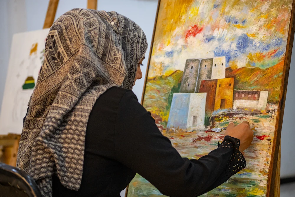An artist paints at the Al-Raqqa Cultural and Art Center.  (Photo / Ali Ali)