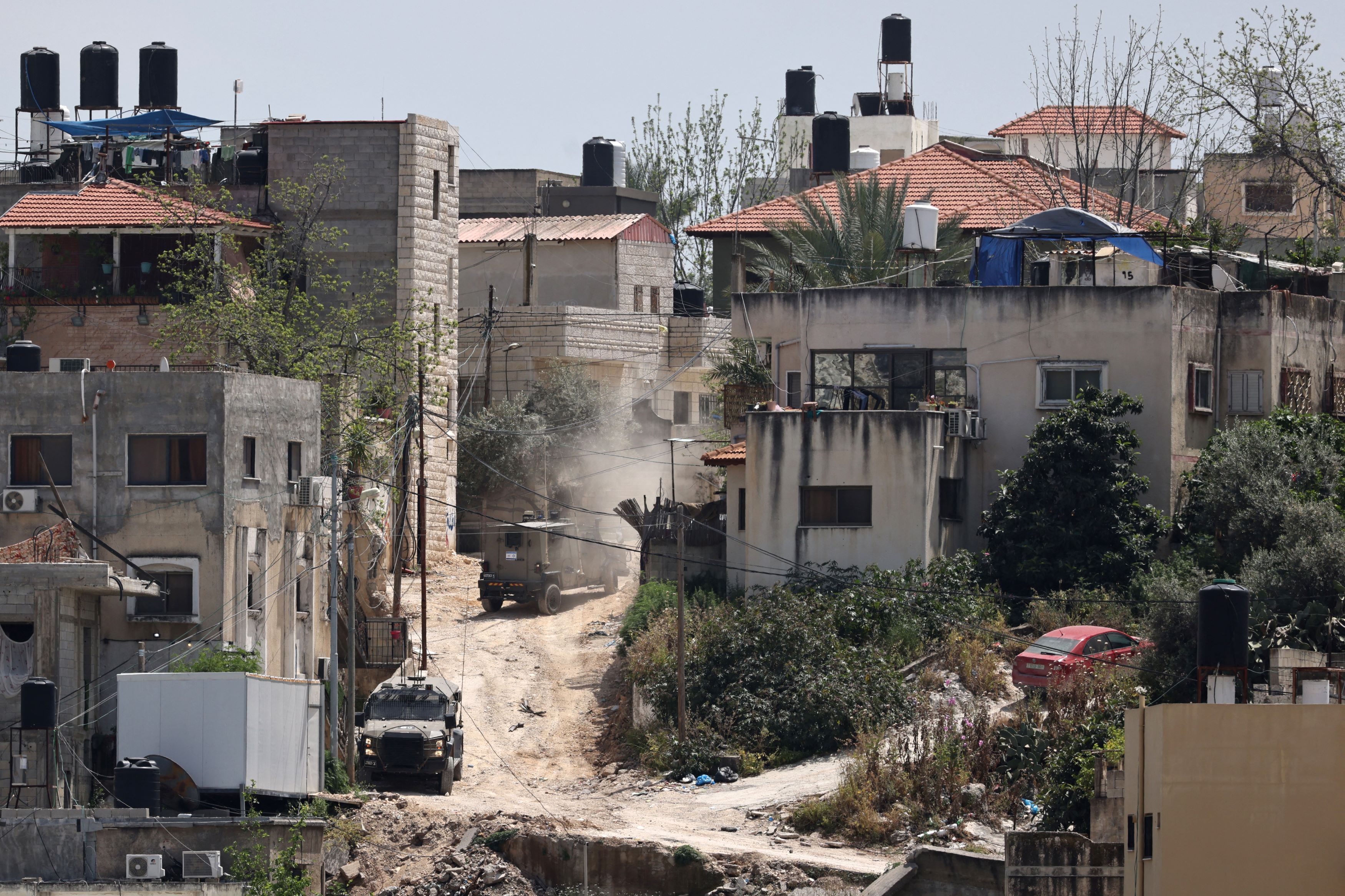 Des soldats israéliens conduisent sur une route lors d'un raid dans le camp de réfugiés palestiniens de Nur Shams, en Cisjordanie occupée, le 20 avril 2024. (AFP)