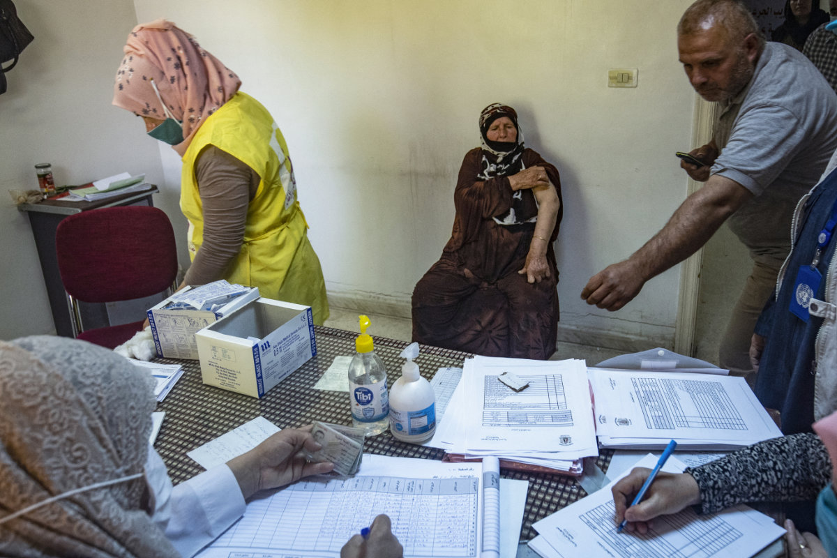 Un médecin syrien administre le vaccin contre la Covid-19 fourni par l’OMS et le Fonds des nations unies pour l'enfance (Unicef) aux habitants de la ville de Kamichli, dans le nord-est de la Syrie, le 24 mai 2021. (AFP)