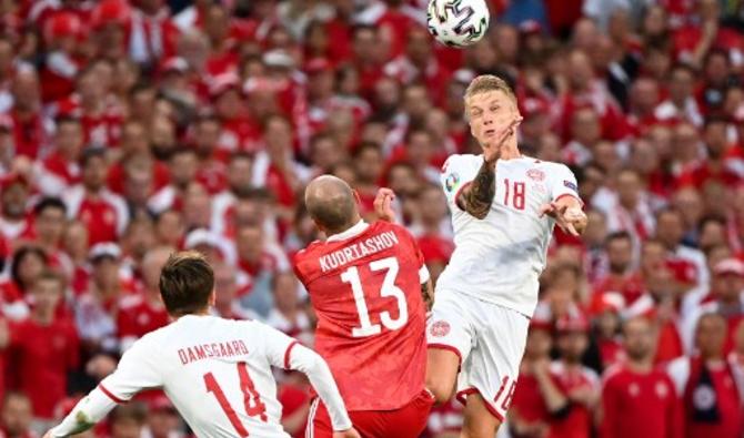 Foule de supporters derrière le défenseur danois Daniel Wass (d) et le russe Fedor Kudryashov lors du match de football du groupe B de l'UEFA EURO 2020 entre la Russie et le Danemark au stade Parken de Copenhague le 21 juin 2021. (Jonathan Nackstrand / Pool / AFP)