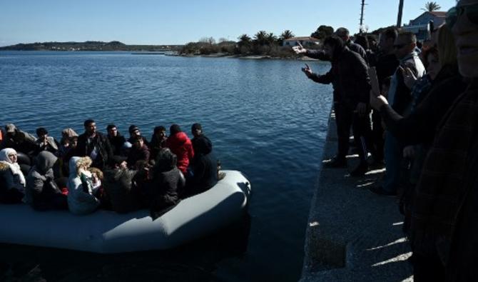 Des migrants sont vus sur un bateau pneumatique alors que des résidents locaux les empêchent de débarquer sur l'île de Lesbos, le 1er mars 2020 (Photo, AFP)