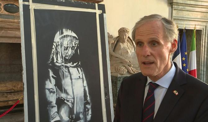 «C’est un jour très symbolique parce que nous avons la remise de la porte du Bataclan peinte par Banksy et qui a été dérobée, volée l’an dernier au Bataclan», déclare Christian Masset, l'ambassadeur de France en Italie, le 14 juillet 2020. (Photo, AFP) 