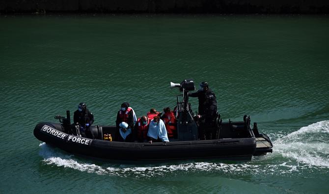 Des migrants sont vus sur le canot en caoutchouc de la UK Border Force, après avoir été récupérés en mer alors qu'ils tentaient de traverser la Manche et amenés à la marina de Douvres, dans le sud-est de l'Angleterre, le 16 juin 2022. (Photo, AFP)