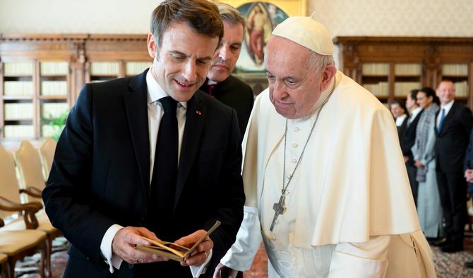 Le pape François échange des cadeaux avec le président français Emmanuel Macron lors d'une audience privée au Vatican, le 24 octobre 2022. (Photo, AFP)