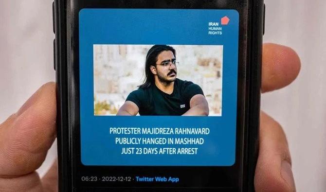 Une personne dans la capitale chypriote Nicosie vérifie un téléphone le 12 décembre 2022, affichant un tweet sur l'exécution annoncée par les autorités iraniennes de Majidreza Rahnavard. (Photo, AFP)